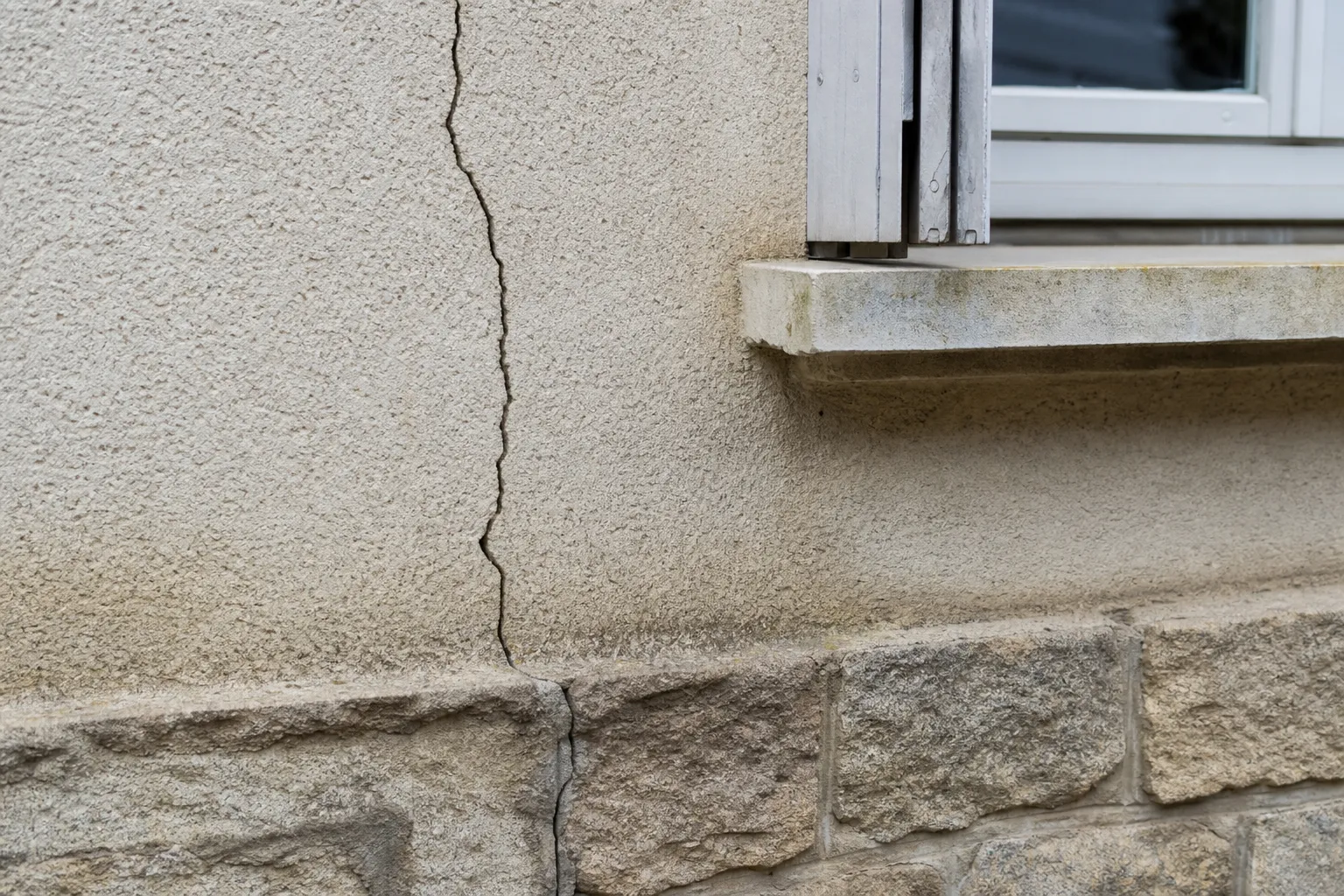 Fissure verticale sur la façade d'une maison, contrôle structurel lors d'une expertise avant achat